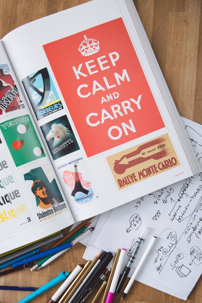 Artistic desk setup features graphic design book and tools, inspiring creativity.